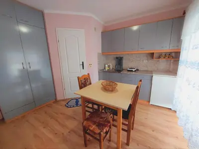 a kitchen with a table and chairs in a room at Apartments Nikolić in Soko Banja
