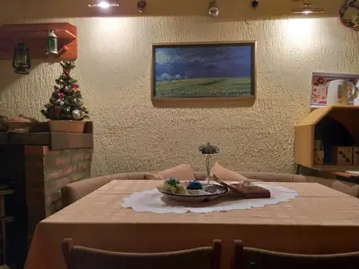 a table with a plate of food on it with a christmas tree at GreenPointMountainHouse for 6 persons in Kopaonik
