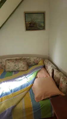 a couch with pillows on it in a room at GreenPointMountainHouse for 6 persons in Kopaonik
