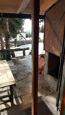 an open door to a patio with a picnic table at GreenPointMountainHouse for 6 persons in Kopaonik