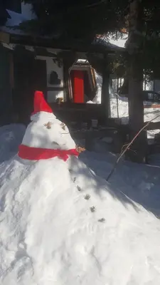 a snowman with a red hat in a pile of snow at GreenPointMountainHouse for 6 persons in Kopaonik