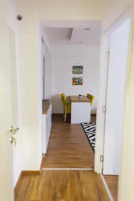 a hallway with a table and chairs in a room at NEW Center Apartments in Niš