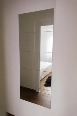a mirror on a wall next to a bedroom at NEW Center Apartments in Niš