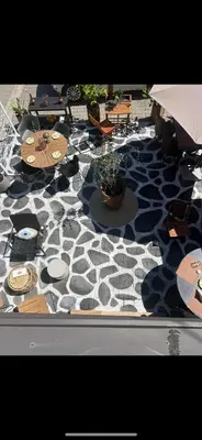 a black and white patterned floor with chairs and tables at Villa Grazia in Vladičin Han