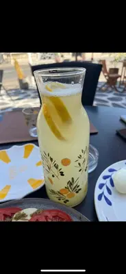 a glass vase of lemonade sitting on a table at Villa Grazia in Vladičin Han