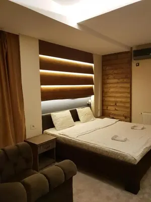 a bedroom with a bed and a couch at Villa Grazia in Vladičin Han