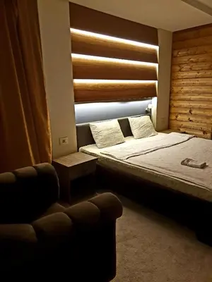 a bedroom with two beds and a chair and a window at Villa Grazia in Vladičin Han