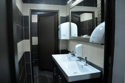 a bathroom with a sink and two mirrors at Hotel Golf in Kruševac