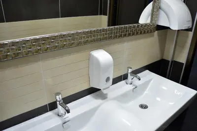 a bathroom with a white sink and a mirror at Hotel Golf in Kruševac