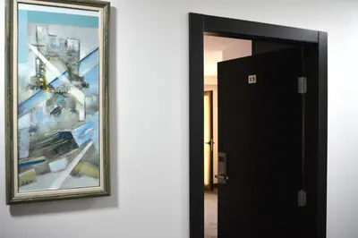 a painting hanging on a wall next to a door at Hotel Golf in Kruševac