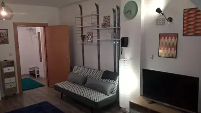 a living room with a couch and a flat screen tv at Apartman-Vila Nikola, 064jedansedamdvatridevetnulatri in Kopaonik