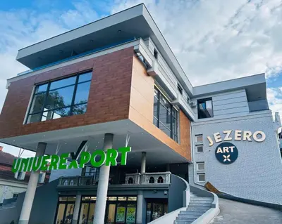 a building with a sign in front of it at Apartmansko naselje JEZERO in Vrnjačka Banja