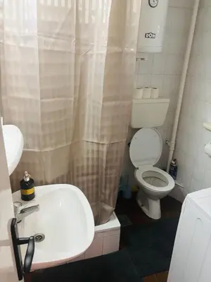 a bathroom with a white sink and a toilet at Apartmansko naselje JEZERO in Vrnjačka Banja