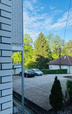 a view of a parking lot with two cars parked at Apartmansko naselje JEZERO in Vrnjačka Banja