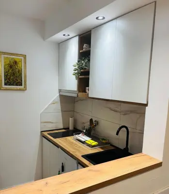 a kitchen with a sink and a counter top at Apartmansko naselje JEZERO in Vrnjačka Banja