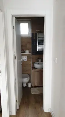 a bathroom with a toilet and a sink at Apartman Four Seasons Kopaonik in Kopaonik