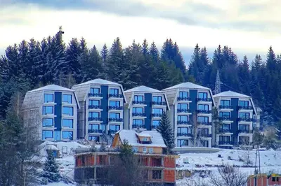 a group of apartment buildings in the snow at Apartman Four Seasons Kopaonik in Kopaonik