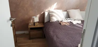 a bedroom with a bed and a table with a lamp at Apartman Four Seasons Kopaonik in Kopaonik