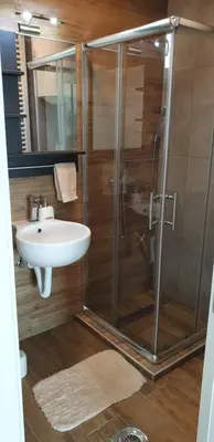 a bathroom with a shower and a sink at Apartman Four Seasons Kopaonik in Kopaonik