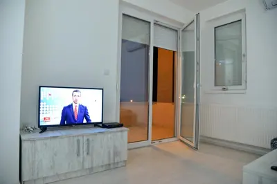 a living room with a flat screen tv on a table at BEST Apartments in Paraćin