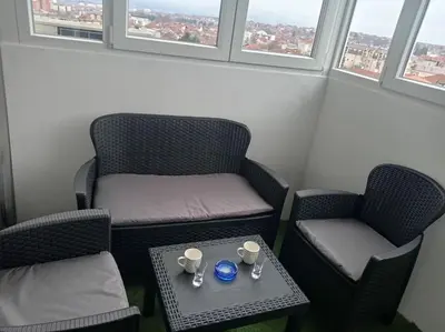 a small room with two chairs and a table with two cups at Apartman DUNJA sa terasom in Vranje