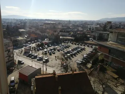 a parking lot with parked cars in a city at Apartman DUNJA sa terasom in Vranje
