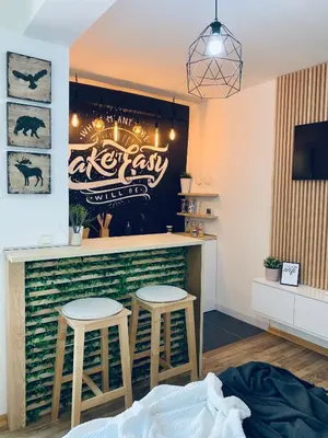 a bar with two stools in a room at Apartment Take a breath in Vrnjačka Banja