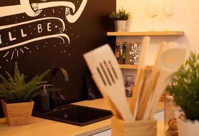 a kitchen counter with a sink and some plants at Apartment Take a breath in Vrnjačka Banja