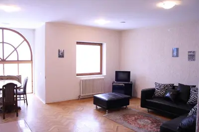 a living room with a couch and a table at Villa Kostic Kopaonik in Kopaonik