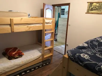 a room with two bunk beds and a mirror at Vila Idila in Crni Vrh