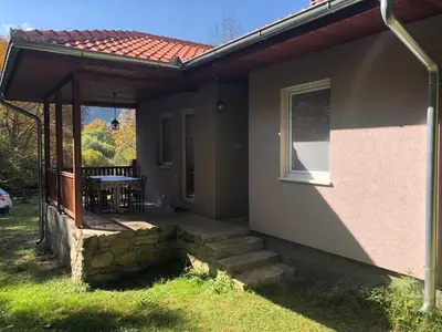 a patio of a house with a table and a window at Vila Idila in Crni Vrh