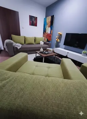a living room with a couch and a tv at Fast Sleep & Go 1 in Paraćin