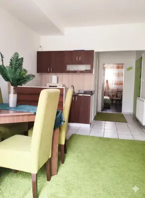 a kitchen and dining room with a table and yellow chairs at Fast Sleep & Go 1 in Paraćin