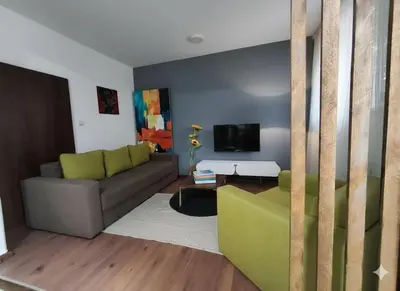 a living room with a couch and a tv at Fast Sleep & Go 1 in Paraćin