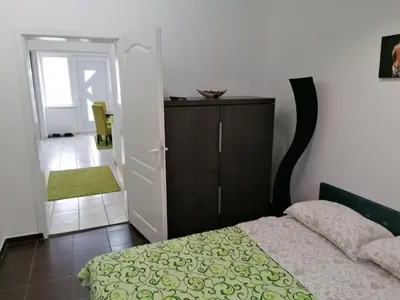 a bedroom with a bed and a cabinet and a door at Fast Sleep & Go 1 in Paraćin