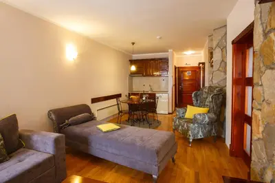 a living room with a couch and a table at Vila Trag in Kopaonik