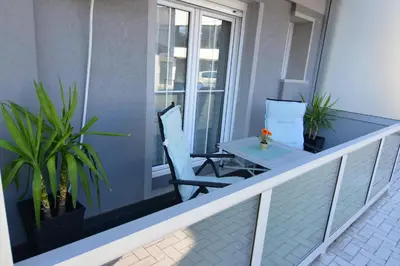 a balcony with two chairs and a table on it at Apartman Jovanović in Vrnjačka Banja