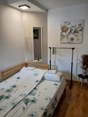 a bedroom with a bed with a floral bedspread at Apartman Jovanović in Vrnjačka Banja