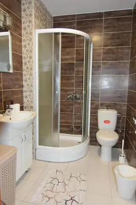 a bathroom with a shower and a toilet and a sink at Apartman Jovanović in Vrnjačka Banja
