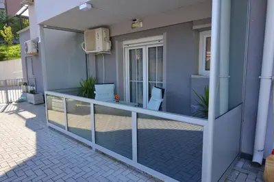 a balcony of a house with a glass wall at Apartman Jovanović in Vrnjačka Banja