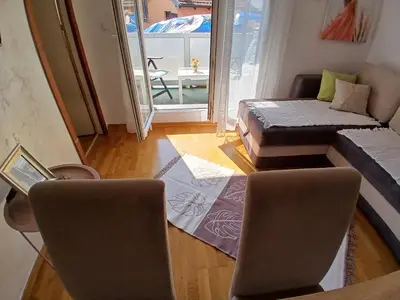 a living room with a bed and a couch at Apartman Jovanović in Vrnjačka Banja