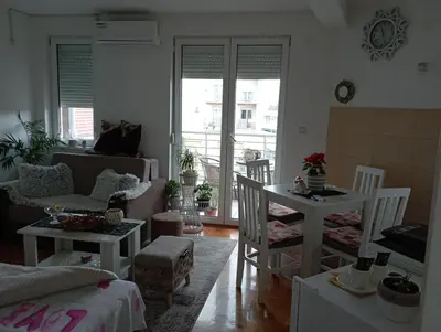 a living room with a couch and a table at Агни in Vrnjačka Banja