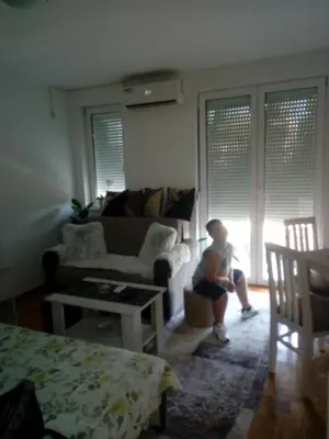 a little boy sitting in a living room at Агни in Vrnjačka Banja