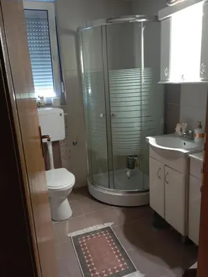 a bathroom with a shower and a toilet and a sink at Агни in Vrnjačka Banja