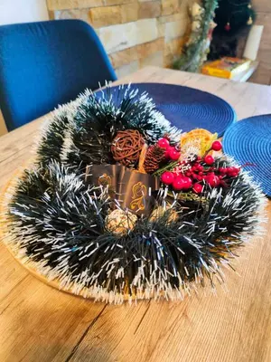 a christmas wreath on top of a wooden table at Milmari L4 in Kopaonik