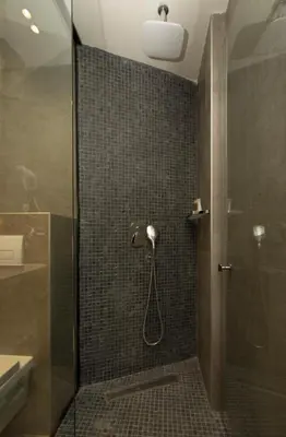 a bathroom with a shower with a glass door at BOUTIQUE 25h by Eva stay 018 in Niš