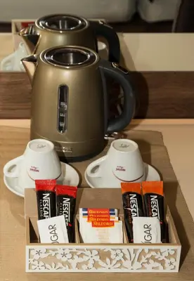 a box with a tea kettle on a table at BOUTIQUE 25h by Eva stay 018 in Niš