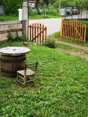 a bench sitting next to a table and a wooden fence at VILA BOJANA in Inovo