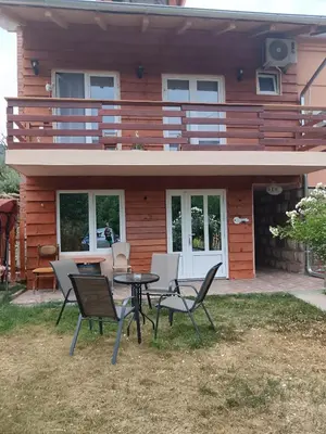 a house with a table and chairs in front of it at VILA BOJANA in Inovo