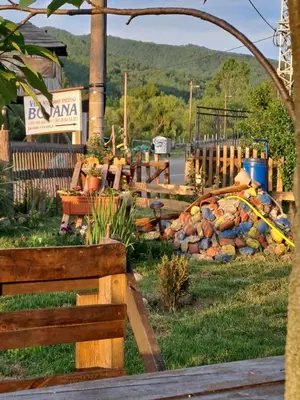 a garden with a fence and a pile of rocks at VILA BOJANA in Inovo
